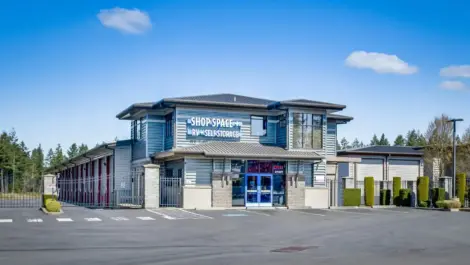 Self-storage facility with a two-story building and rows of storage units.